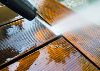 Dock being power washed removing mold from boards with just the right pressure to not fur the top wood